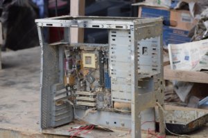 Disassembled desktop computer case showing internal components and metal chassis on work surface